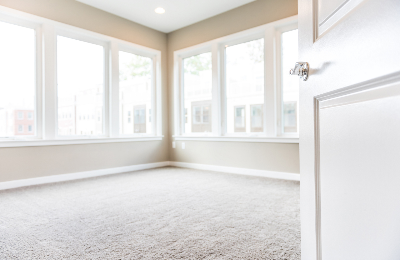 an empty room with the door open in a new home