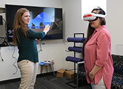 Dr. Mackenzie Shanahan works with a fellow trainee using virtual reality.