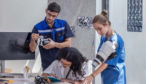 Robotic rehabilitation engineer work with an orthopedic doctor and a surgeon to create somatosensory robotic arms and hands for patients requiring advanced prosthetics or rehabilitation support.